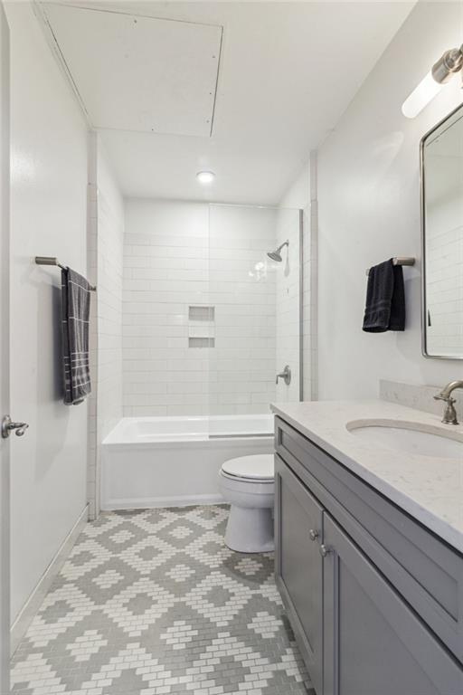 full bathroom with bathing tub / shower combination, toilet, and vanity