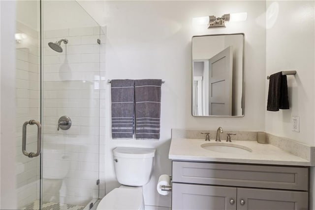 full bathroom featuring vanity, toilet, and a stall shower