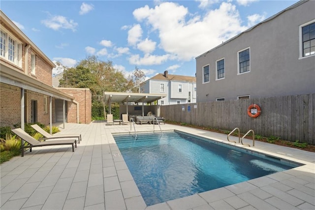 pool with a residential view, fence private yard, and a patio