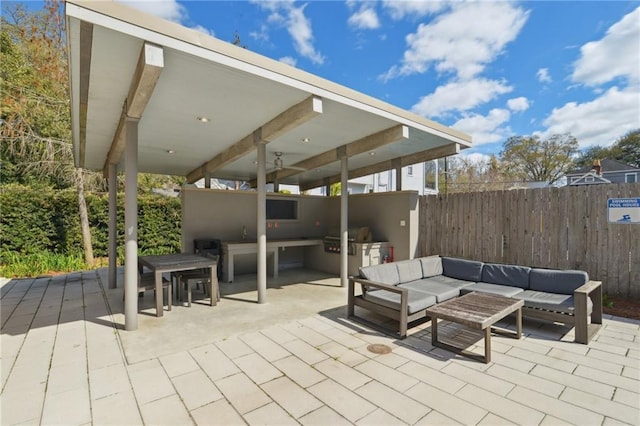 view of patio featuring outdoor lounge area, area for grilling, and fence