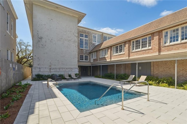 view of pool featuring a fenced in pool, fence, and a patio area