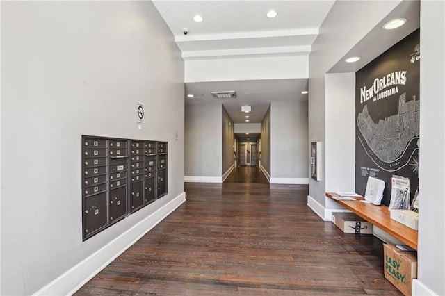 hallway with recessed lighting, mail area, baseboards, and wood finished floors