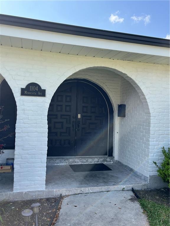 property entrance with brick siding