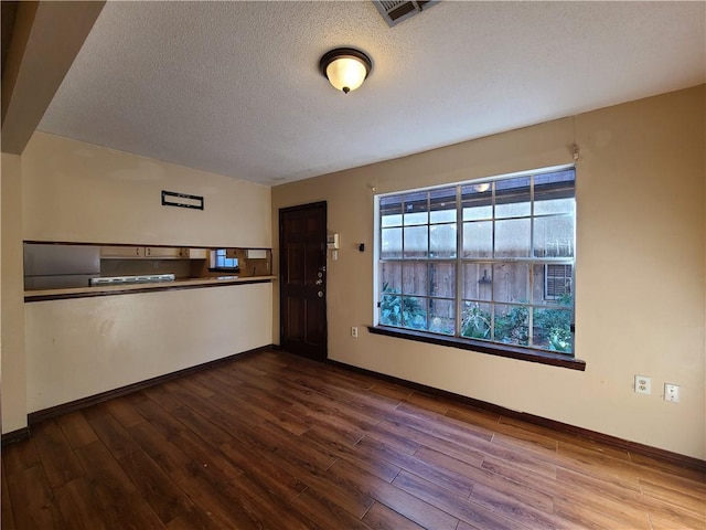 9 Whitney Ave Unit N, Harvey, LA 70058 - unfurnished room featuring a textured ceiling, dark wood finished floors, and baseboards