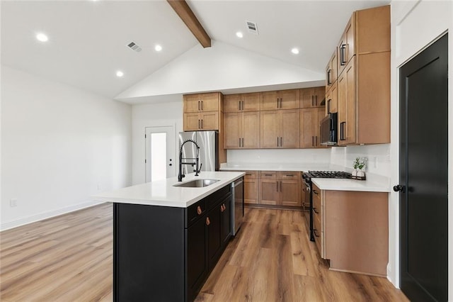 kitchen with visible vents, an island with sink, light countertops, appliances with stainless steel finishes, and a sink