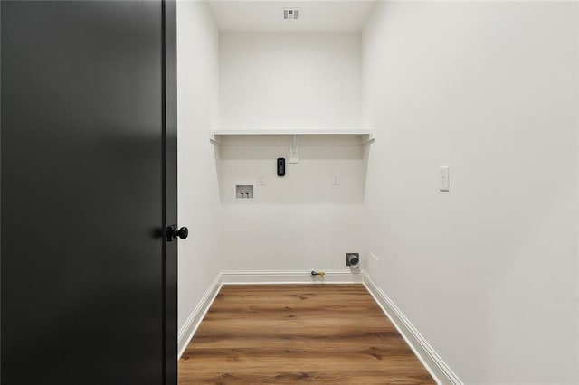 laundry room with visible vents, washer hookup, wood finished floors, baseboards, and laundry area