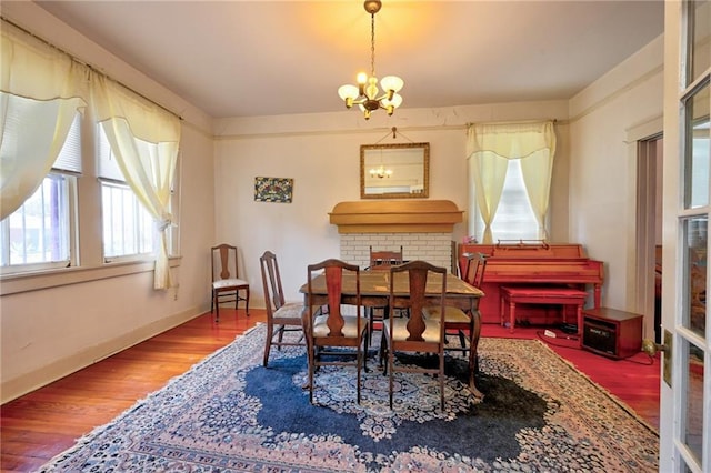 dining room with a notable chandelier and wood finished floors