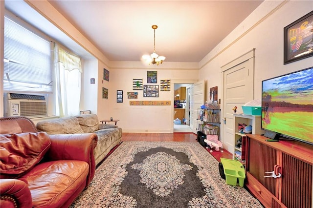 living room featuring cooling unit, an inviting chandelier, and wood finished floors