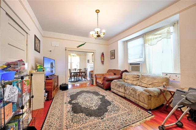 living area featuring a notable chandelier, cooling unit, and wood finished floors