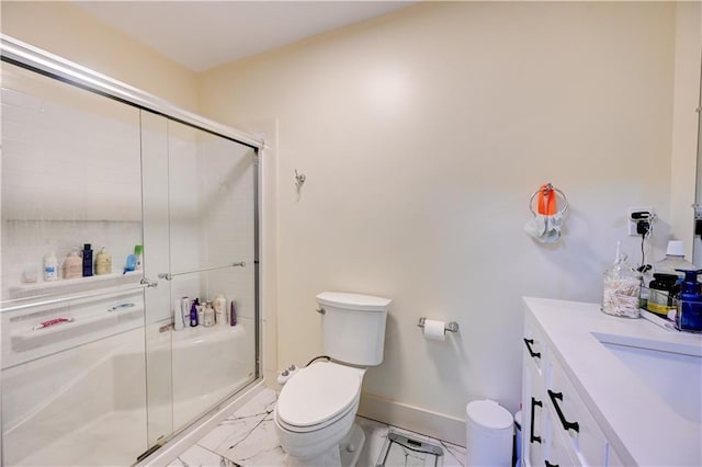 bathroom featuring marble finish floor, toilet, a shower stall, and baseboards