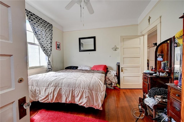 bedroom with wood-type flooring and a ceiling fan