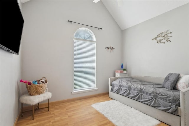 bedroom featuring lofted ceiling and wood finished floors