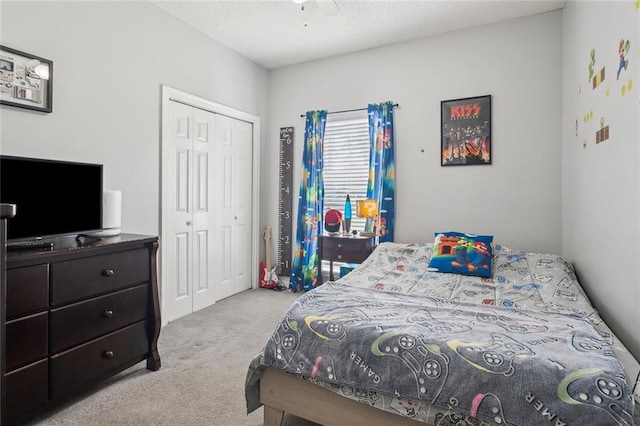 bedroom featuring a closet, a textured ceiling, and carpet floors