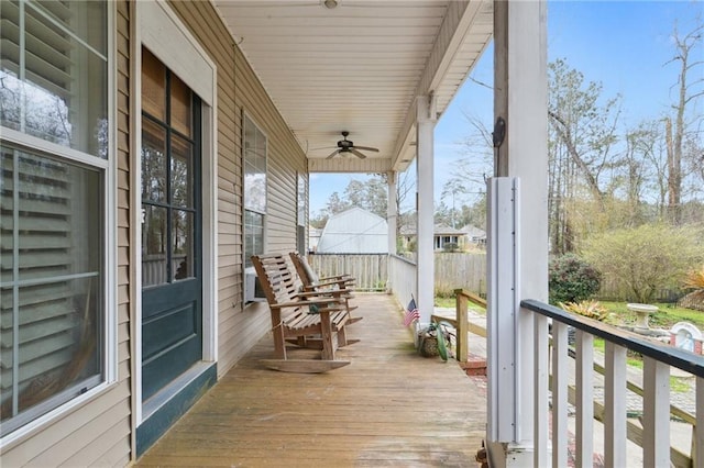 wooden terrace featuring a ceiling fan and covered porch