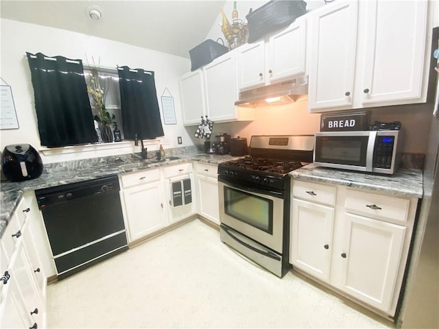 kitchen featuring under cabinet range hood, light stone countertops, appliances with stainless steel finishes, and white cabinets