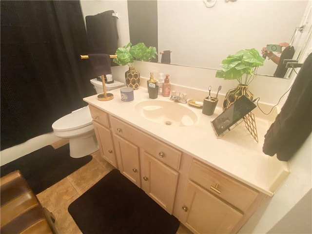 full bathroom featuring tile patterned flooring, toilet, vanity, and walk in shower