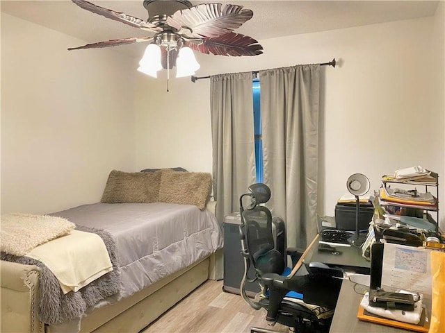 bedroom with wood finished floors and a ceiling fan