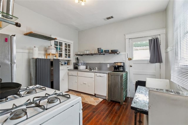 kitchen featuring visible vents, dark wood-type flooring, open shelves, white cabinetry, and white appliances