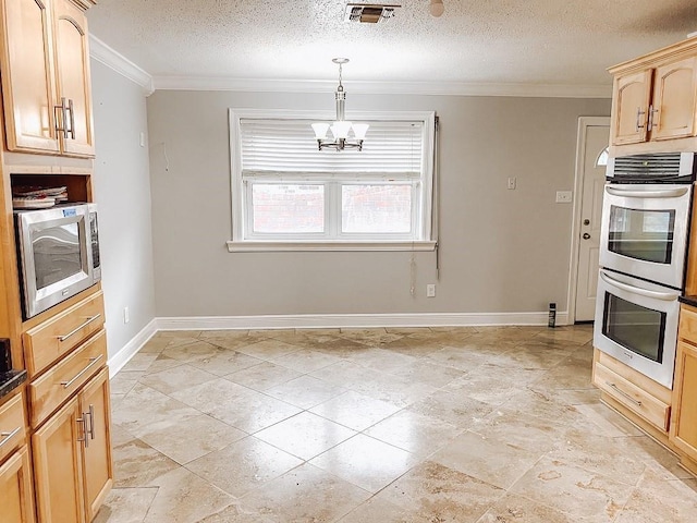 kitchen featuring visible vents, crown molding, baseboards, appliances with stainless steel finishes, and a notable chandelier