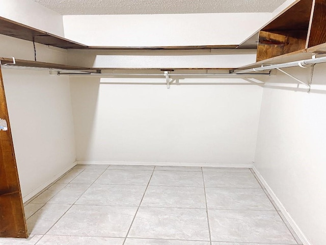 spacious closet with light tile patterned flooring