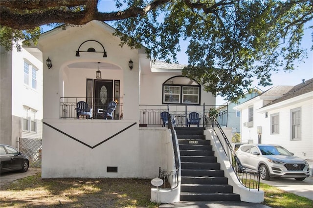 3825 Louisiana Avenue Parkway, New Orleans, LA 70125 - view of front of house featuring stairs, stucco siding, and a porch