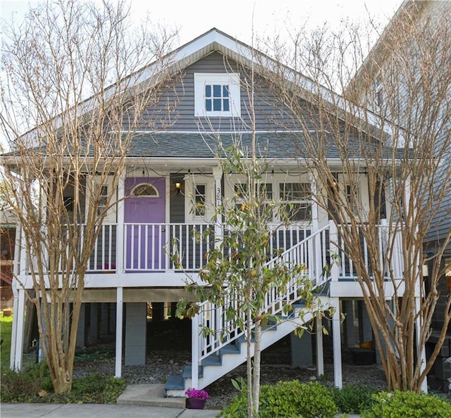 view of front of home featuring stairs and a porch