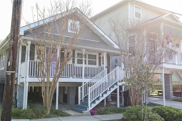 view of front of house with stairway and a porch