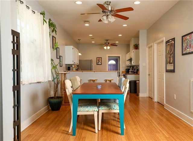 dining area featuring recessed lighting, a ceiling fan, baseboards, and light wood finished floors