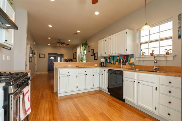 kitchen featuring a ceiling fan, a sink, black dishwasher, stainless steel range with gas cooktop, and a peninsula