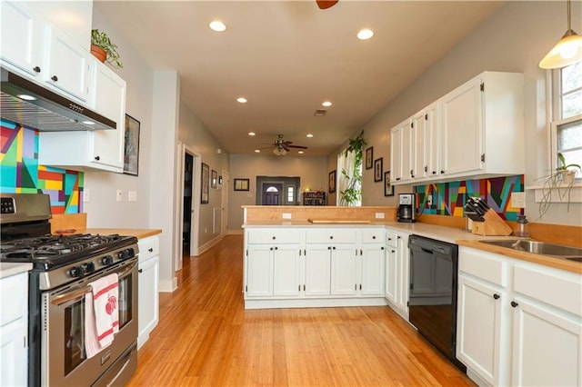 kitchen featuring stainless steel range with gas cooktop, ceiling fan, under cabinet range hood, dishwasher, and a peninsula