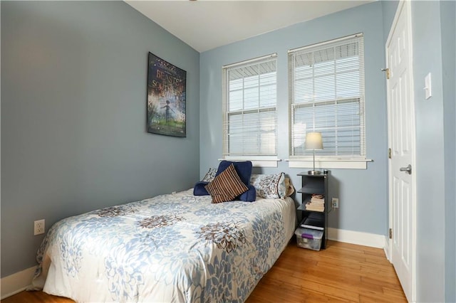 bedroom featuring baseboards and wood finished floors