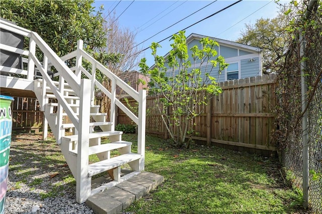 view of yard with stairs and fence