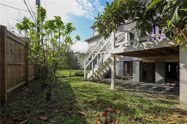 view of yard featuring stairway, a fenced backyard, and a deck