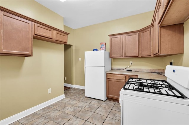143537 France St, New Orleans, LA 70117 - kitchen featuring light tile patterned floors, white appliances, light countertops, and baseboards