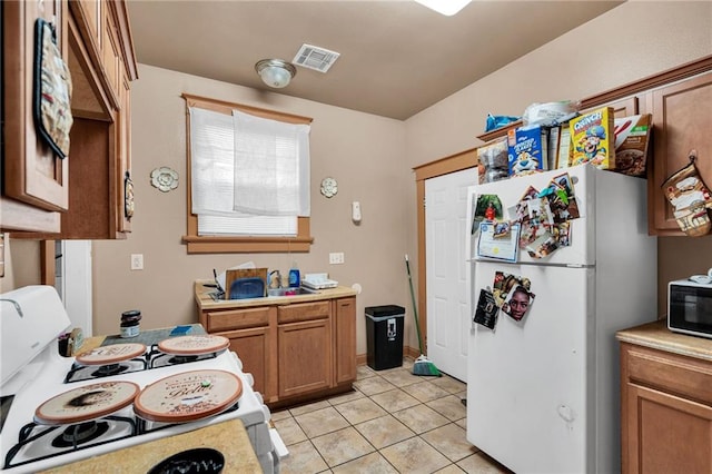 143537 France St, New Orleans, LA 70117 - kitchen featuring visible vents, white appliances, and light countertops