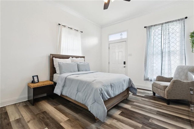 bedroom with baseboards, wood finished floors, ornamental molding, and a ceiling fan