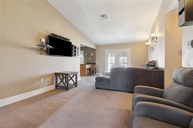 carpeted living room featuring lofted ceiling, baseboards, and visible vents