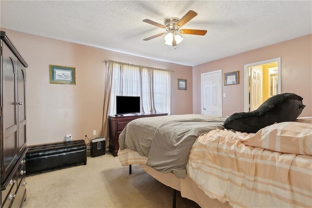 carpeted bedroom with a textured ceiling and ceiling fan