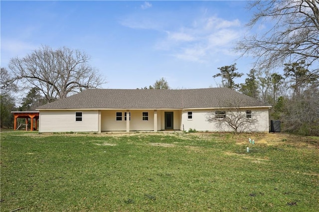 view of front of home with a shingled roof and a front lawn