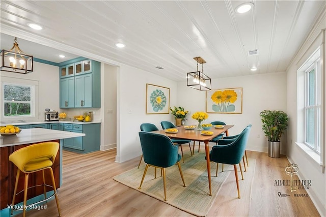dining room featuring recessed lighting, plenty of natural light, a notable chandelier, and light wood-type flooring