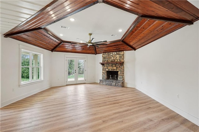 unfurnished living room with light wood finished floors, visible vents, a ceiling fan, and french doors