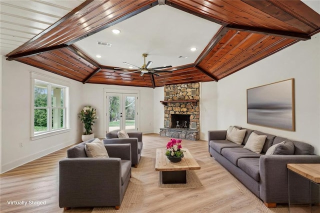 living area with light wood finished floors, french doors, vaulted ceiling, visible vents, and a ceiling fan