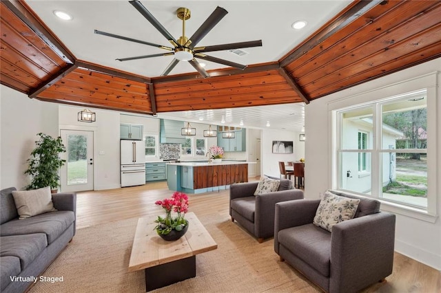 living room featuring recessed lighting, a ceiling fan, visible vents, and light wood-type flooring