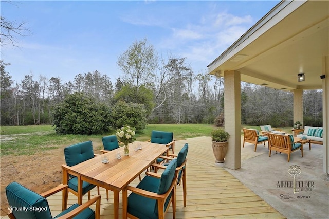 deck featuring a lawn, a patio area, outdoor dining space, and an outdoor hangout area