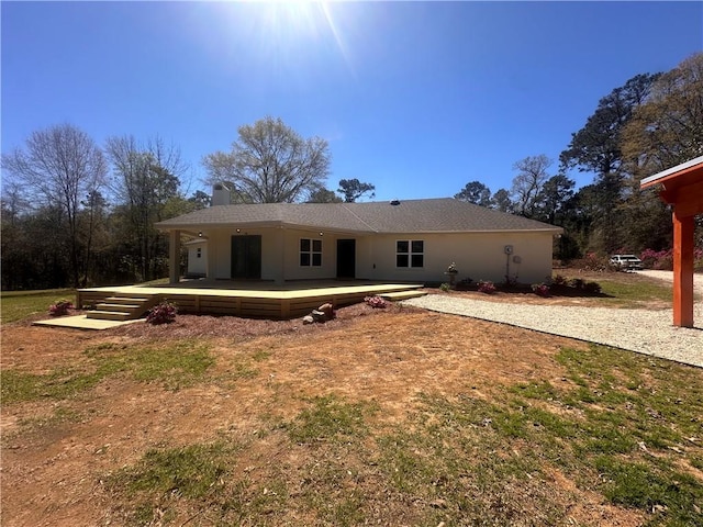 rear view of property with a wooden deck