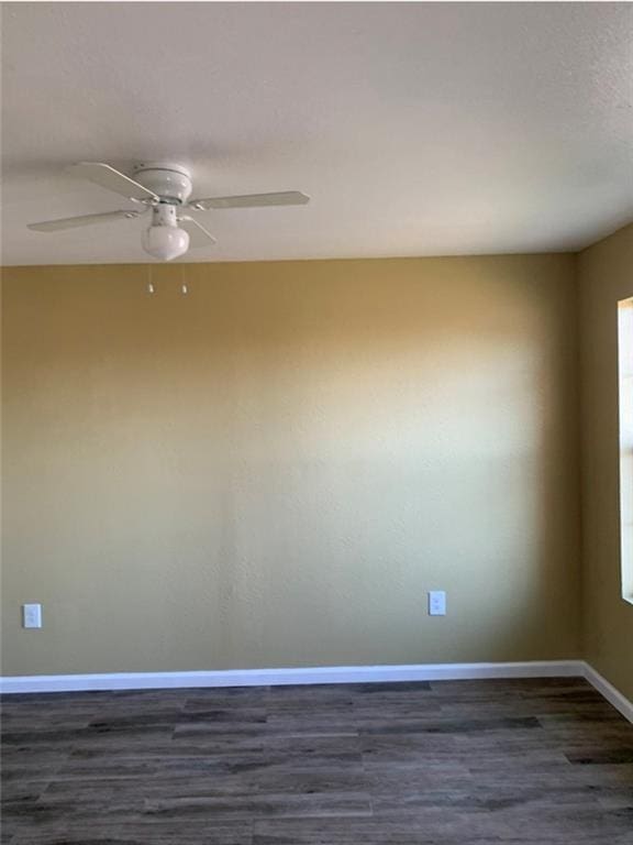 312022 Law St, New Orleans, LA 70117 - empty room with dark wood finished floors, a ceiling fan, and baseboards