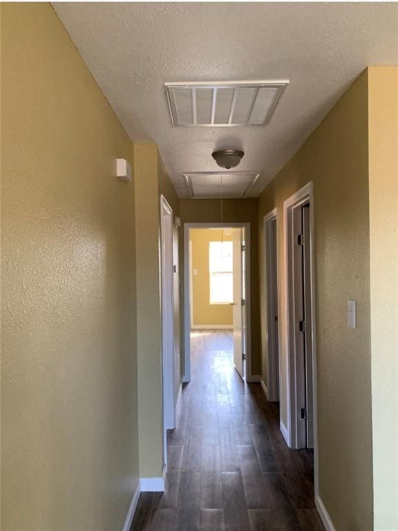 312022 Law St, New Orleans, LA 70117 - hallway featuring attic access, baseboards, and dark wood-type flooring