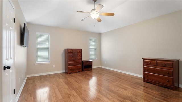 unfurnished bedroom with ceiling fan, baseboards, and wood finished floors