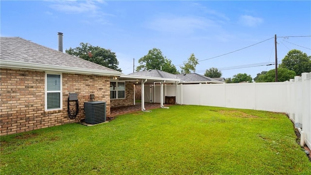 view of yard featuring central AC and a fenced backyard