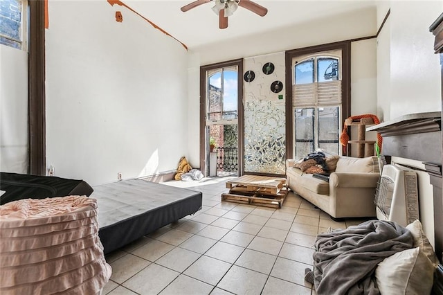 bedroom with access to exterior and light tile patterned floors